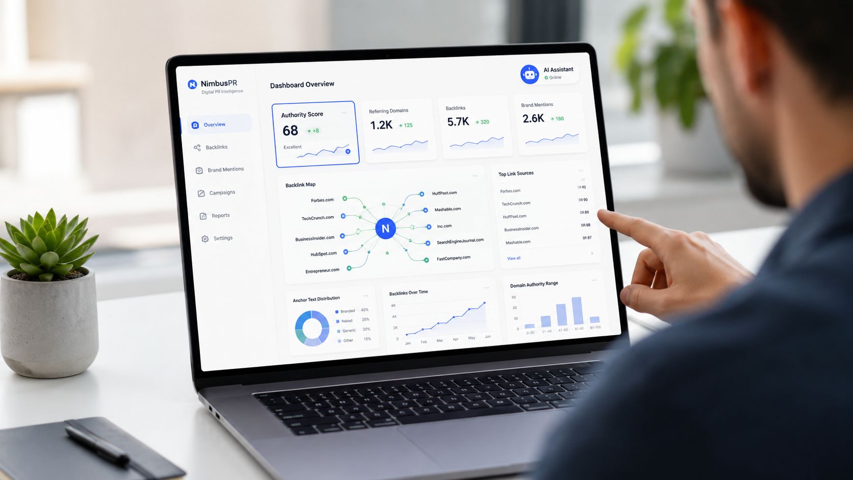 A person pointing at a laptop screen displaying a NimbusPR digital public relations dashboard with various analytics.